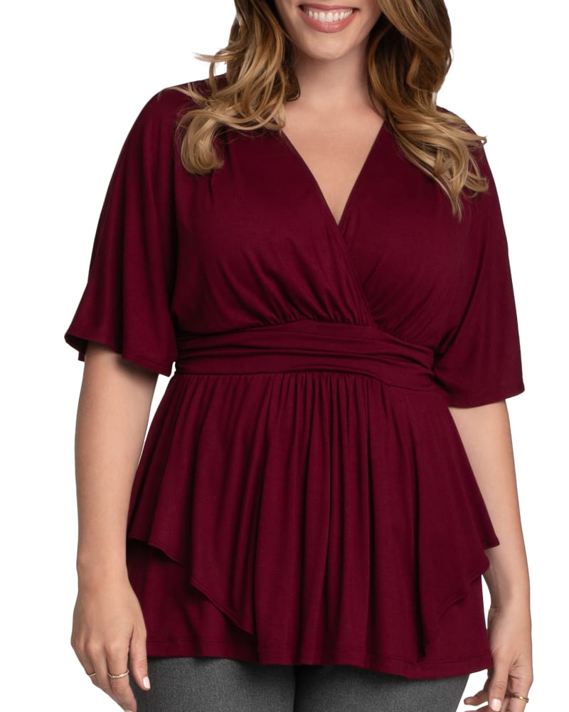 Front of a model wearing a size 0X Marcy Wrap Peplum Top in BURGUNDY by Kiyonna. | dia_product_style_image_id:316108